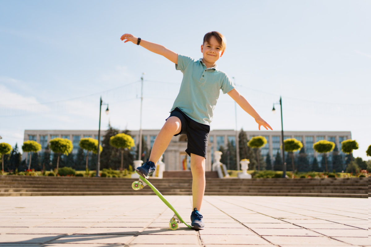 happy-young-boy-playing-skateboard-park-caucasian-kid-riding-penny-board-practicing-skateboard